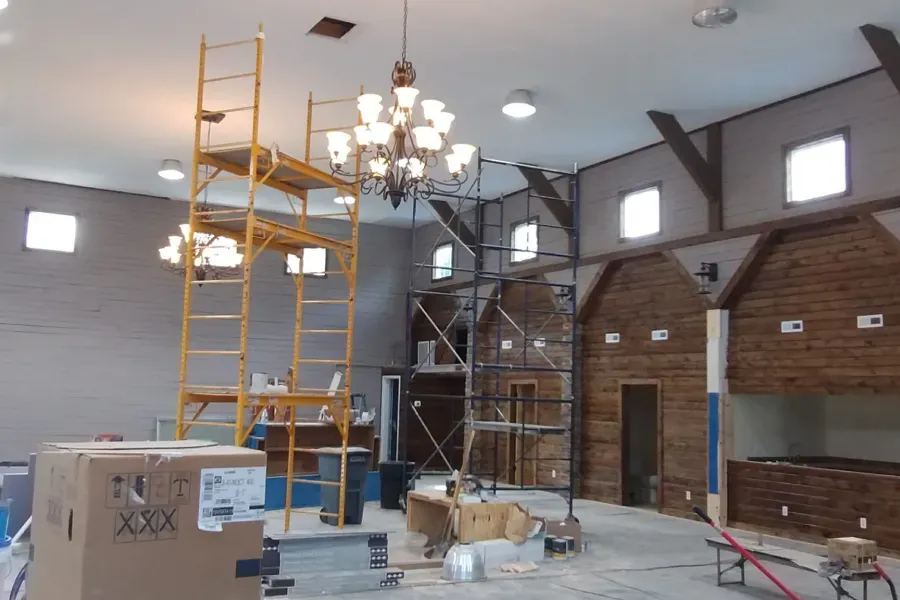 A large room with scaffolding and a box that says xxx