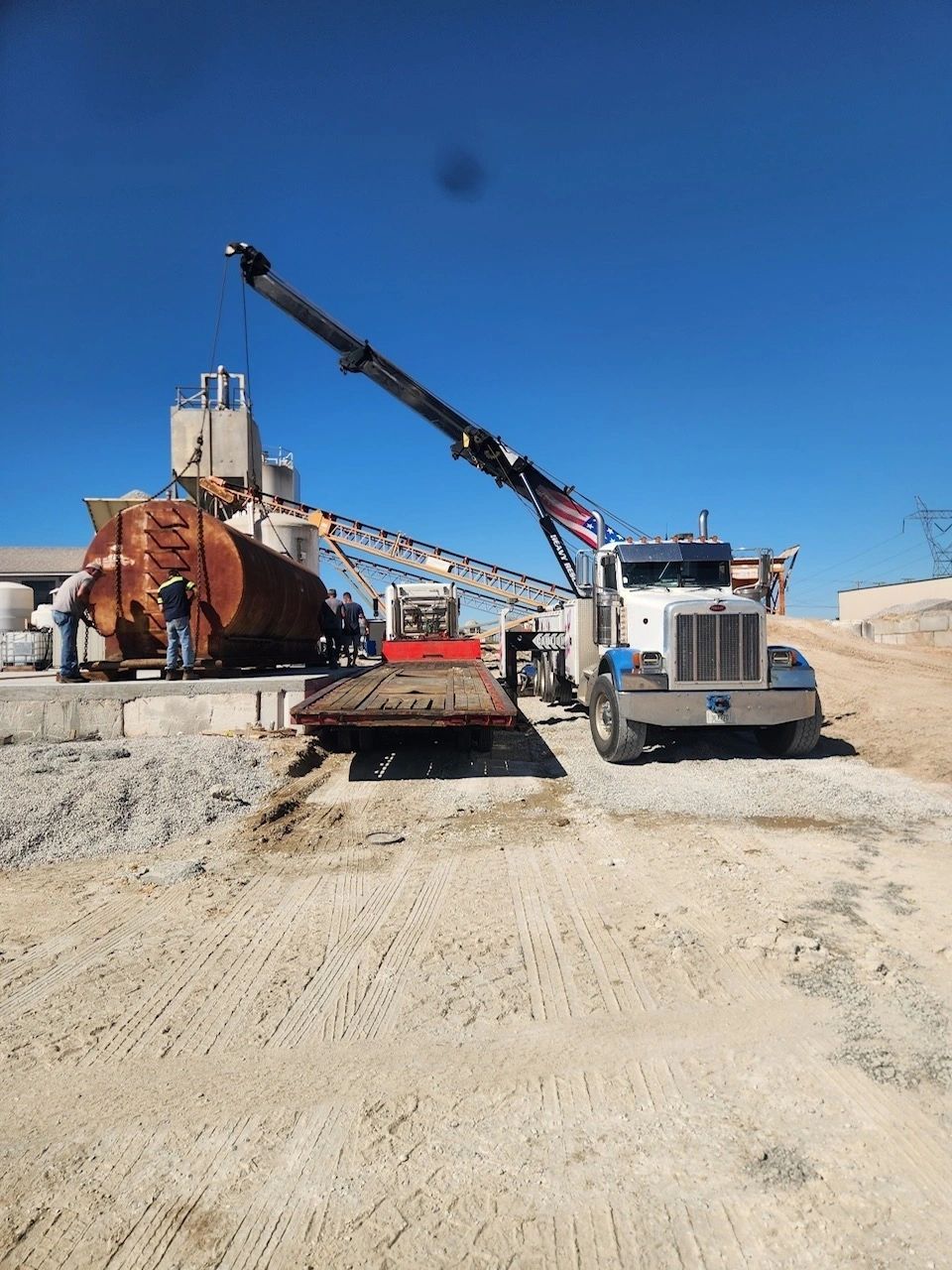 A semi truck with a crane attached to it