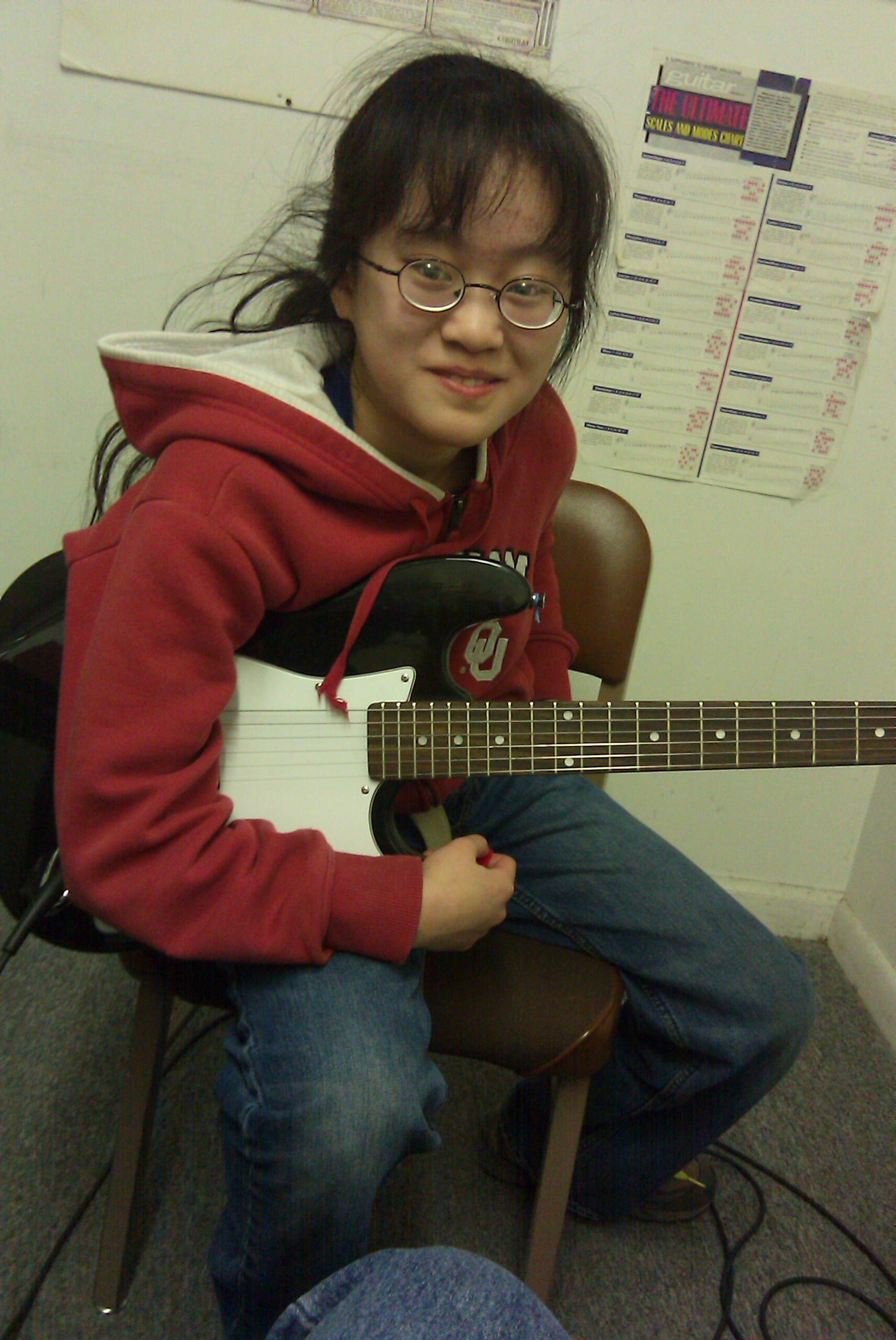 Girl in red jacket with a Strat