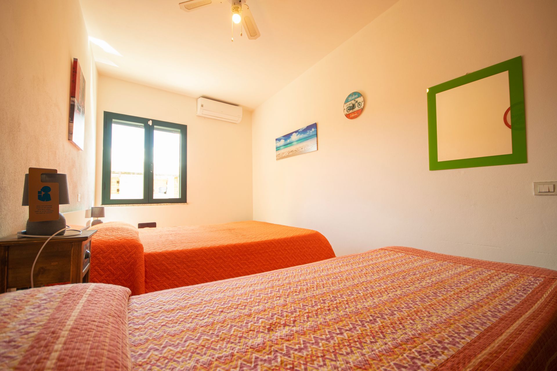 Una camera da letto con due letti e uno specchio sul muro.