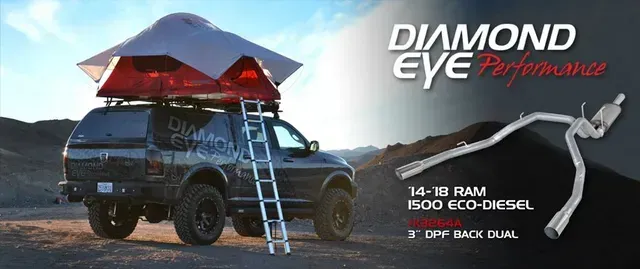 Black truck with rooftop tent in a desert setting with Diamond Eye Performance exhaust system.