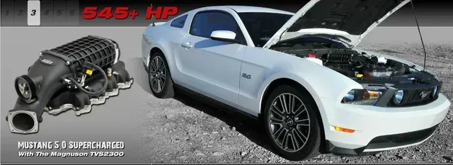 White Ford Mustang with the hood open next to a supercharger, text reads 545+ HP.