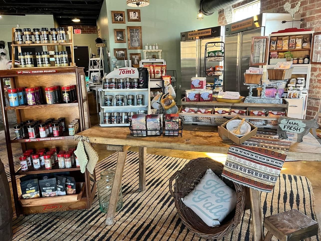 A store filled with lots of products and a table with a pillow on it.