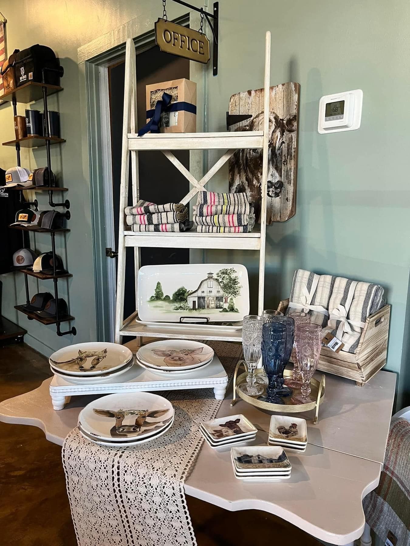 A table with plates and glasses on it in a store.