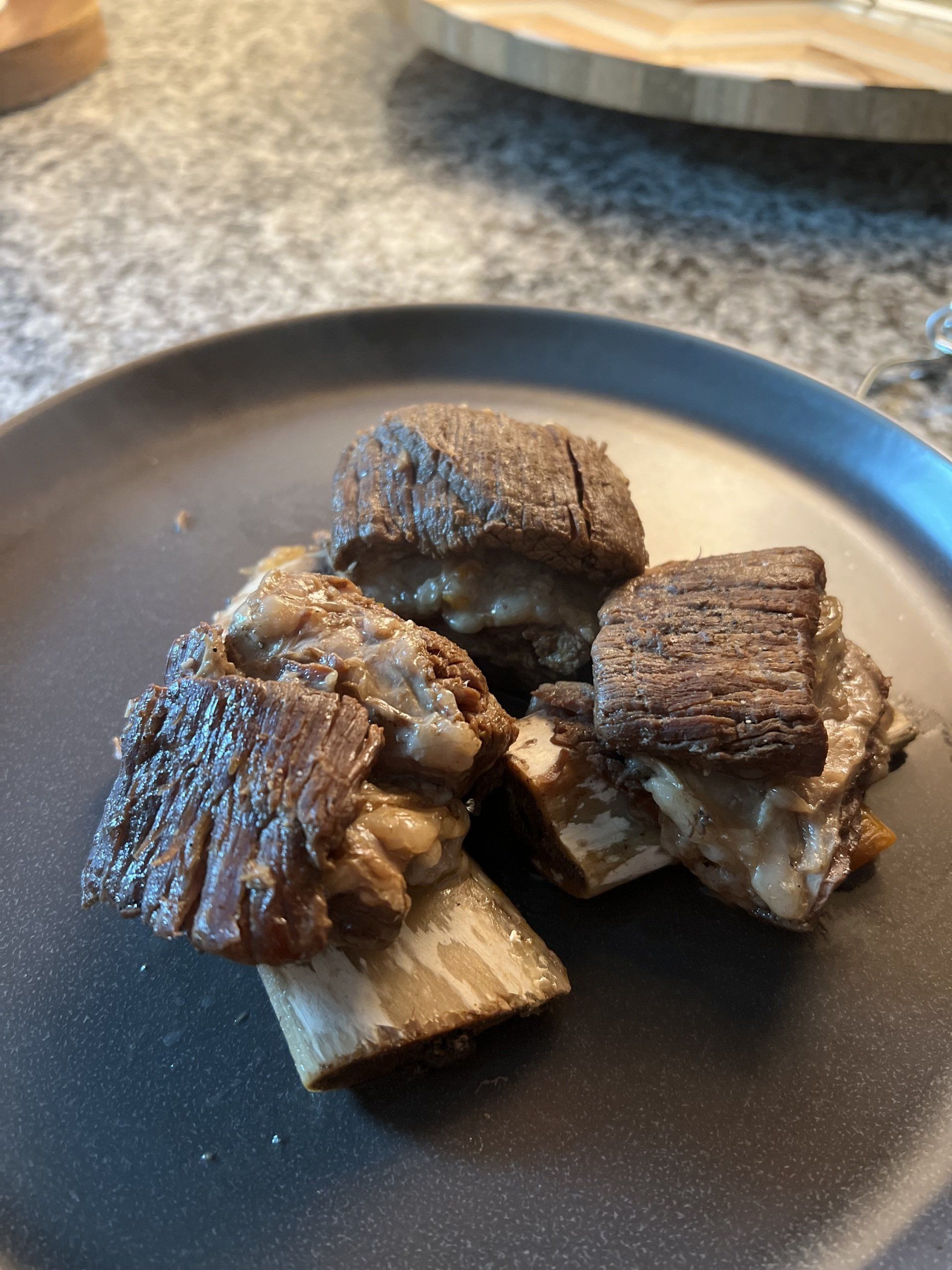 A close up of a plate of meat on a table.