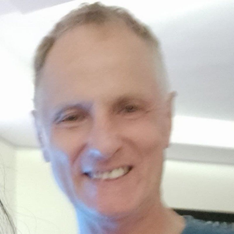 Smiling, fair-skinned man with short hair. Appears to be indoors, smiling, looking directly at the camera.