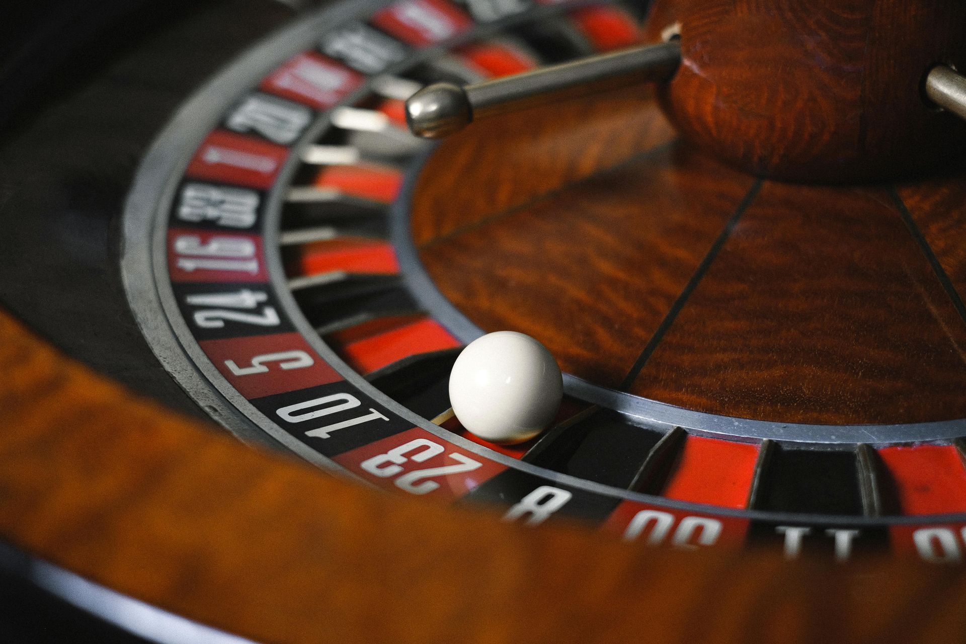 Roulette wheel with white ball settled on red number 23.