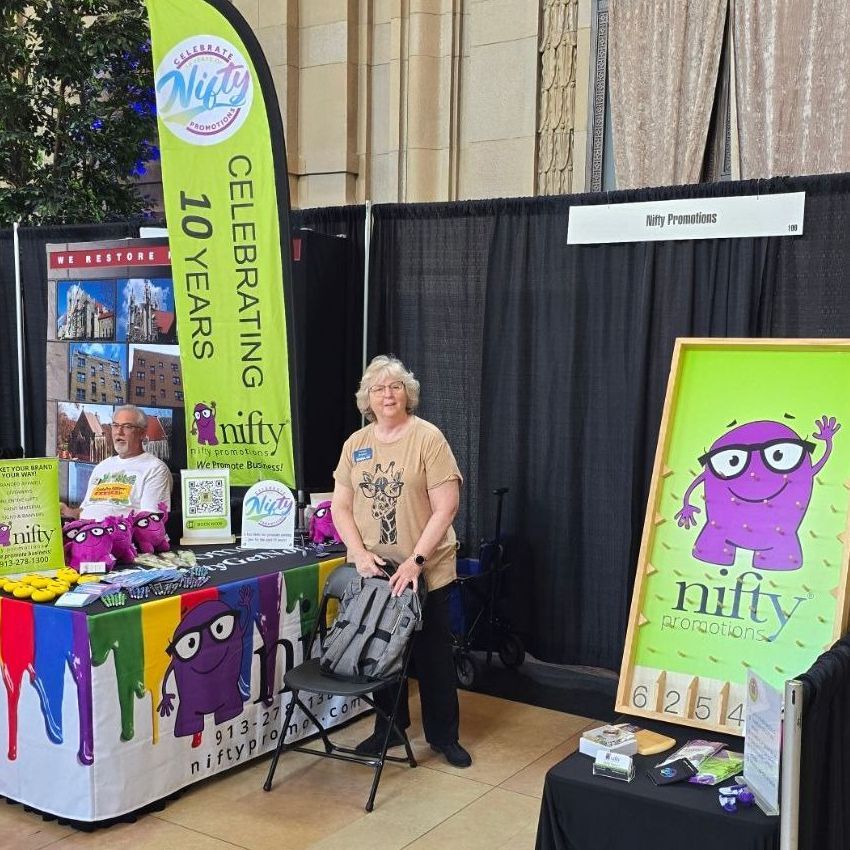 A woman stands in front of a table with a sign that says celebrating 10 years