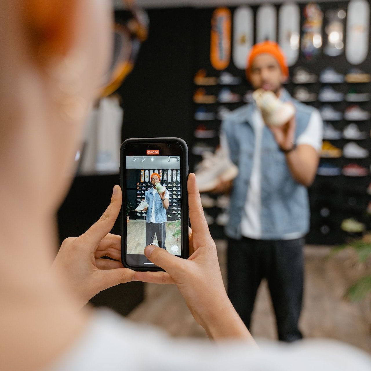 A person is taking a picture of a man with a cell phone.
