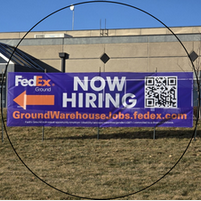 A fedex sign that says now hiring on it