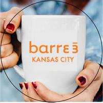 A person is holding a mug that says barre 3 kansas city