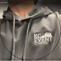 A person is wearing a grey hoodie with the kc event company logo on it.