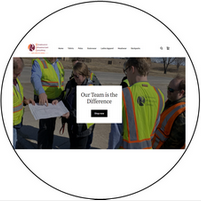 A group of people in safety vests are standing in a circle.