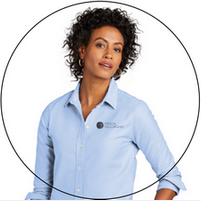 A woman wearing a light blue shirt is standing in a circle.