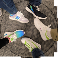 A group of people are standing in a circle with their shoes on