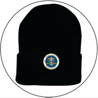 A black beanie with a badge on it is in a circle on a white background.