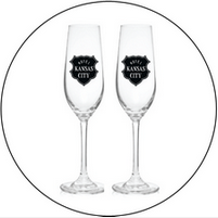 A pair of champagne flutes with a kansas city logo on them.