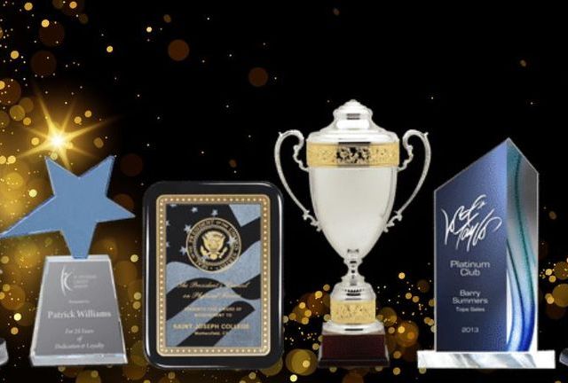 A group of trophies with one that says ' platinum club ' on it