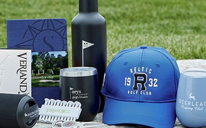 A group of golf related items are sitting on a table.