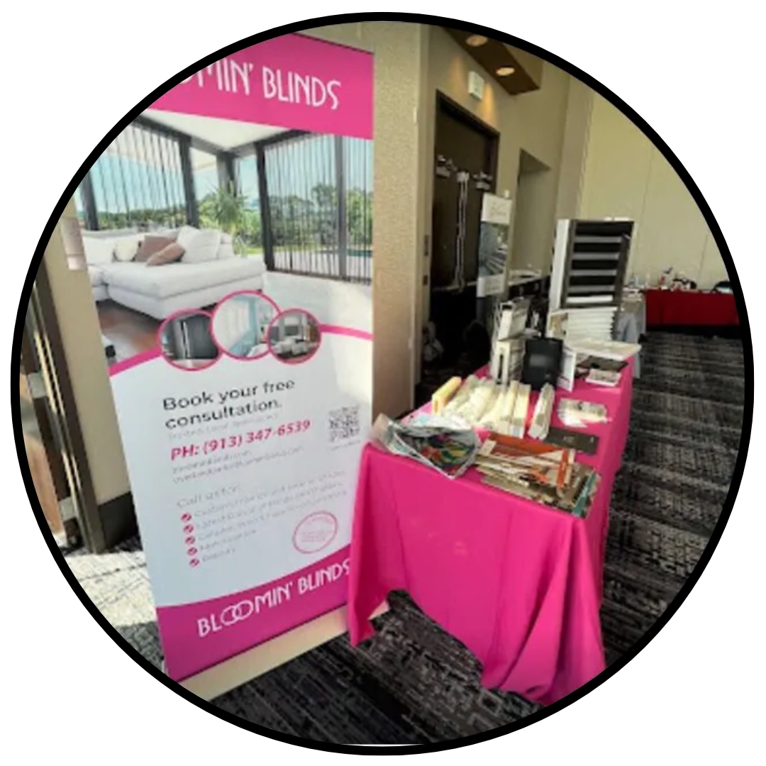 A table with a pink tablecloth and a sign on it.