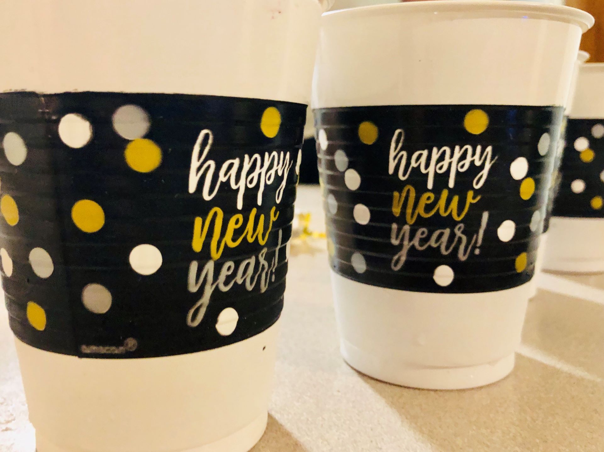 Three cups with happy new year written on them
