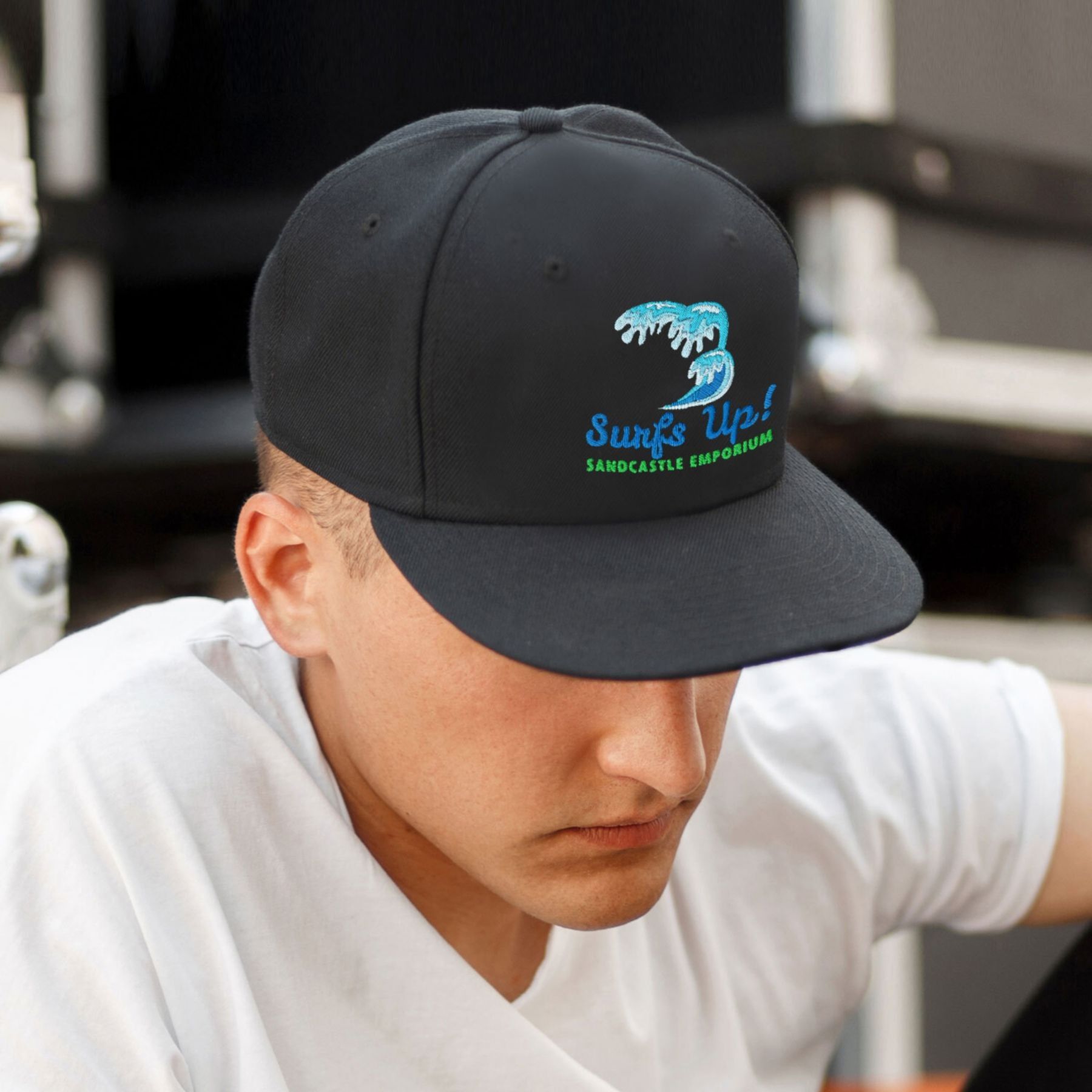 A man wearing a black hat that says surfs up