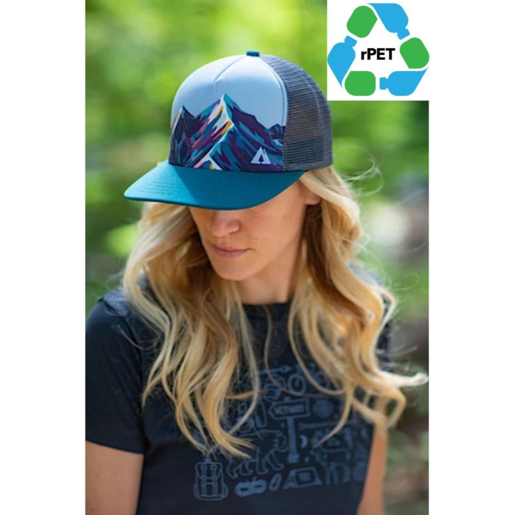 A woman wearing a blue hat with mountains on it