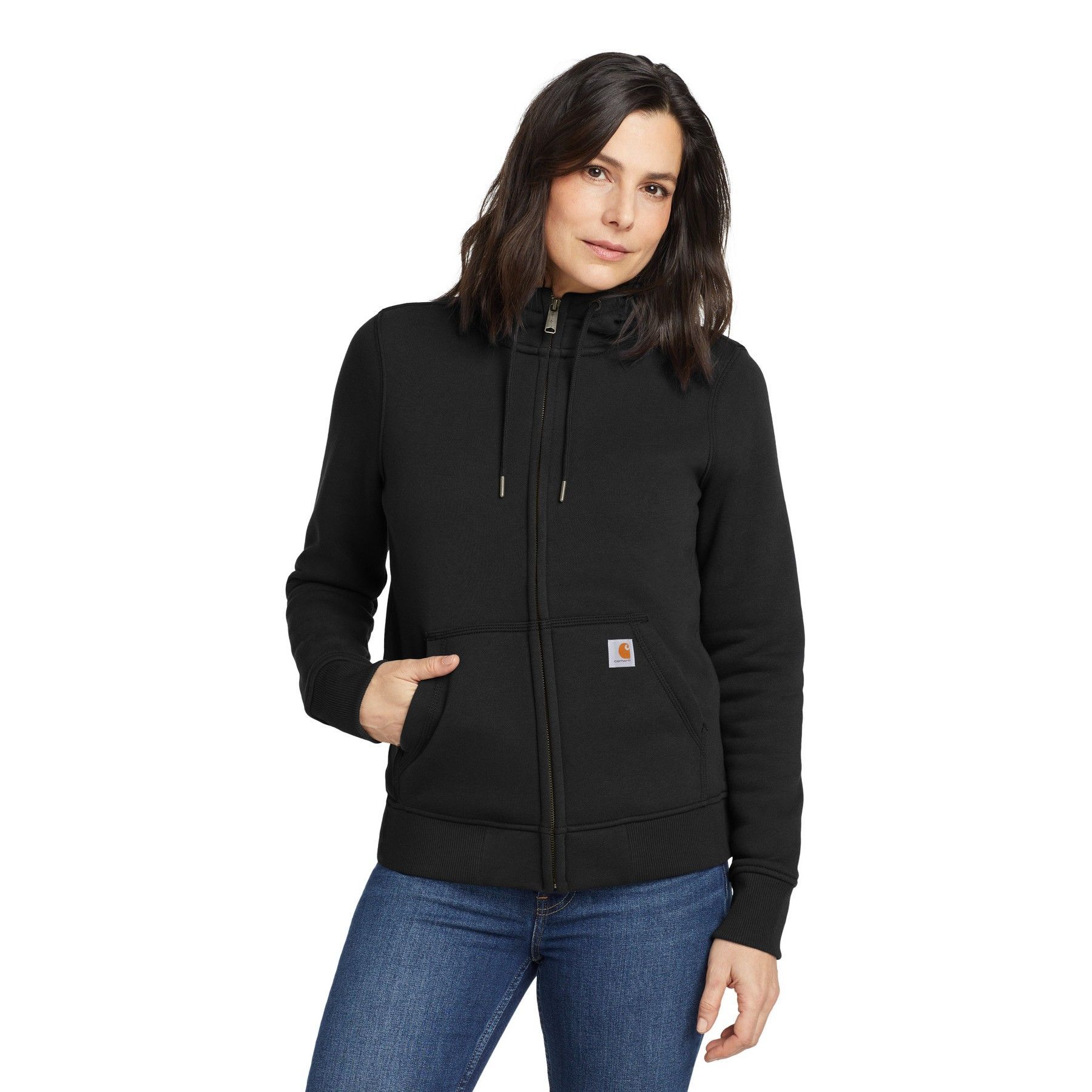 A woman is wearing a black carhartt hoodie and jeans.
