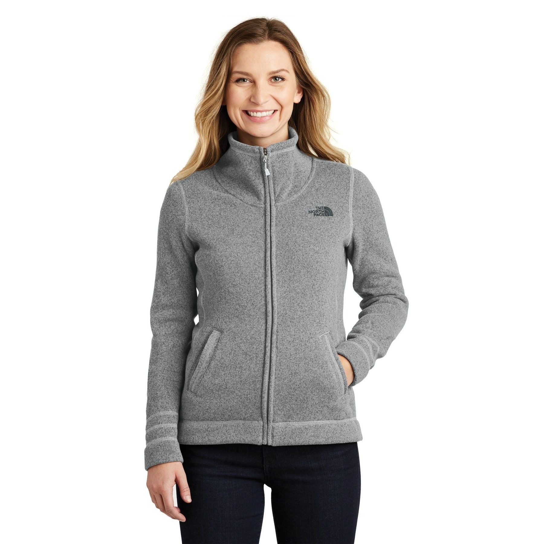 A woman is wearing a grey north face fleece jacket