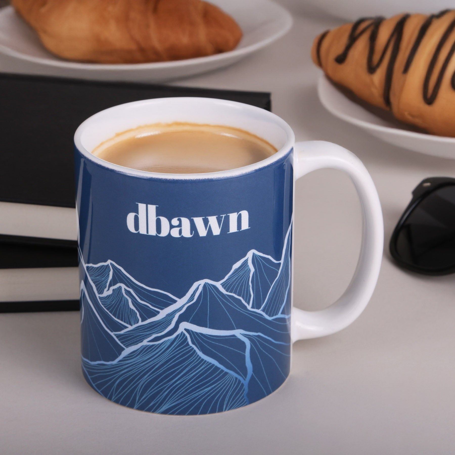 A blue mug with the word dawn on it