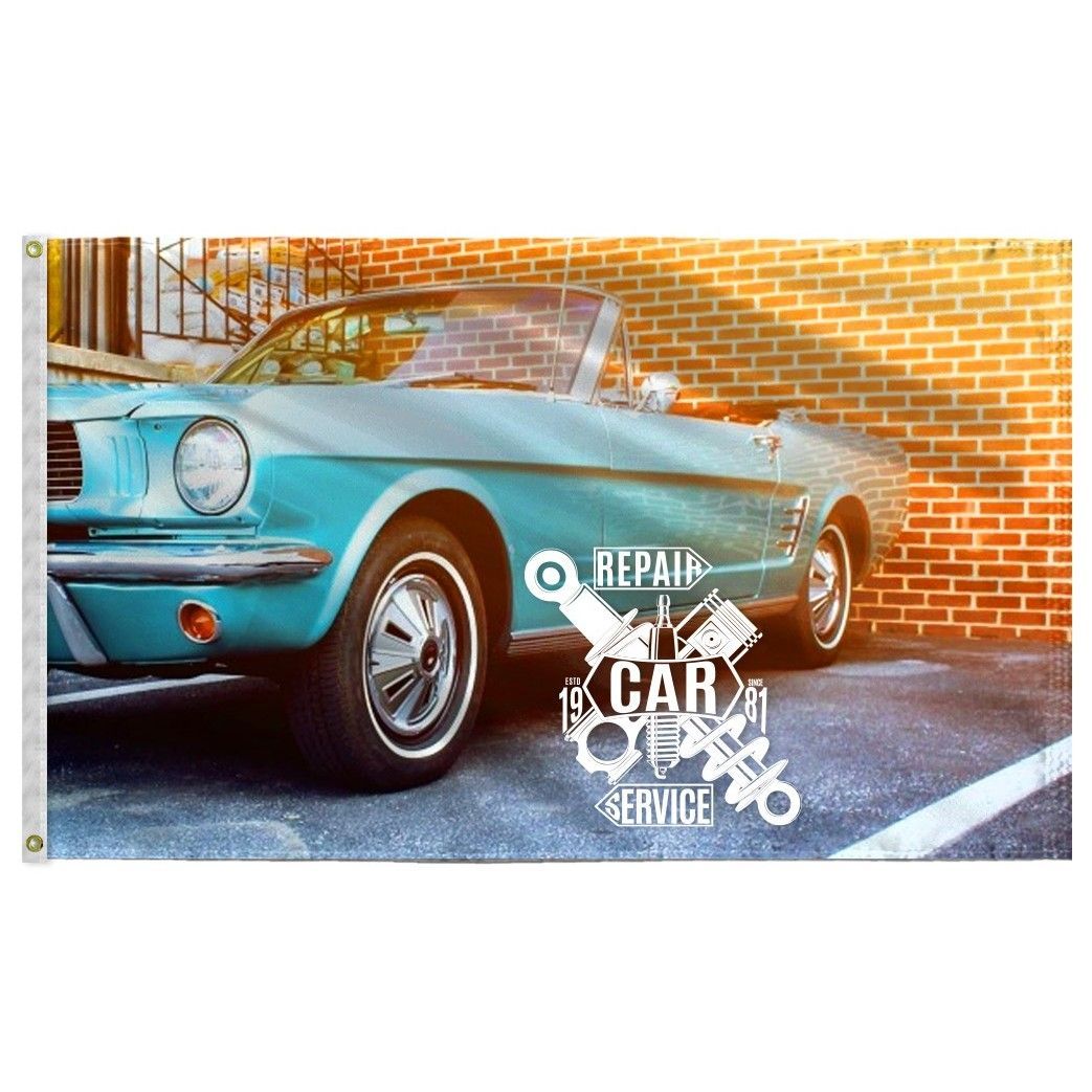 A blue mustang convertible is parked in front of a brick wall.