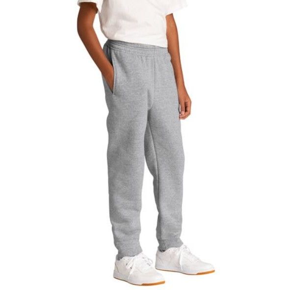 A boy wearing a white shirt and grey sweatpants