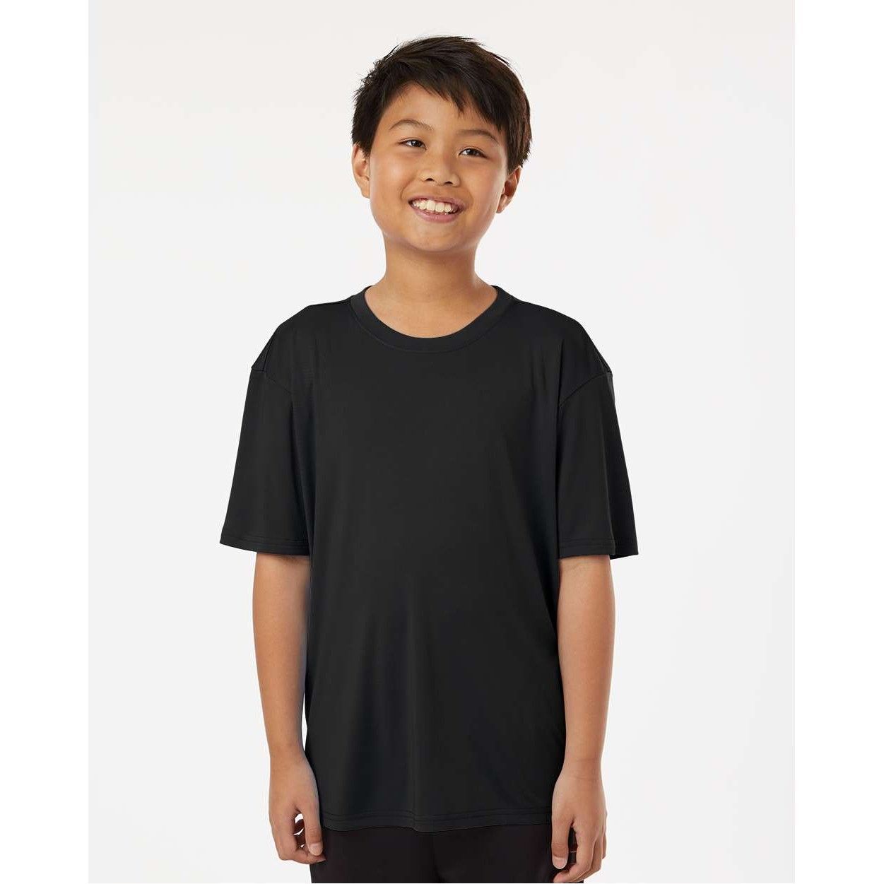 A young boy is wearing a black t-shirt and smiling.