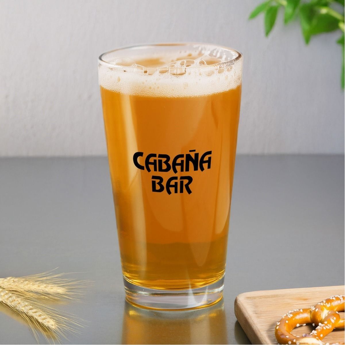 A glass of beer says cabana bar on it