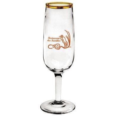 A champagne flute with a gold rim and a bird on it.