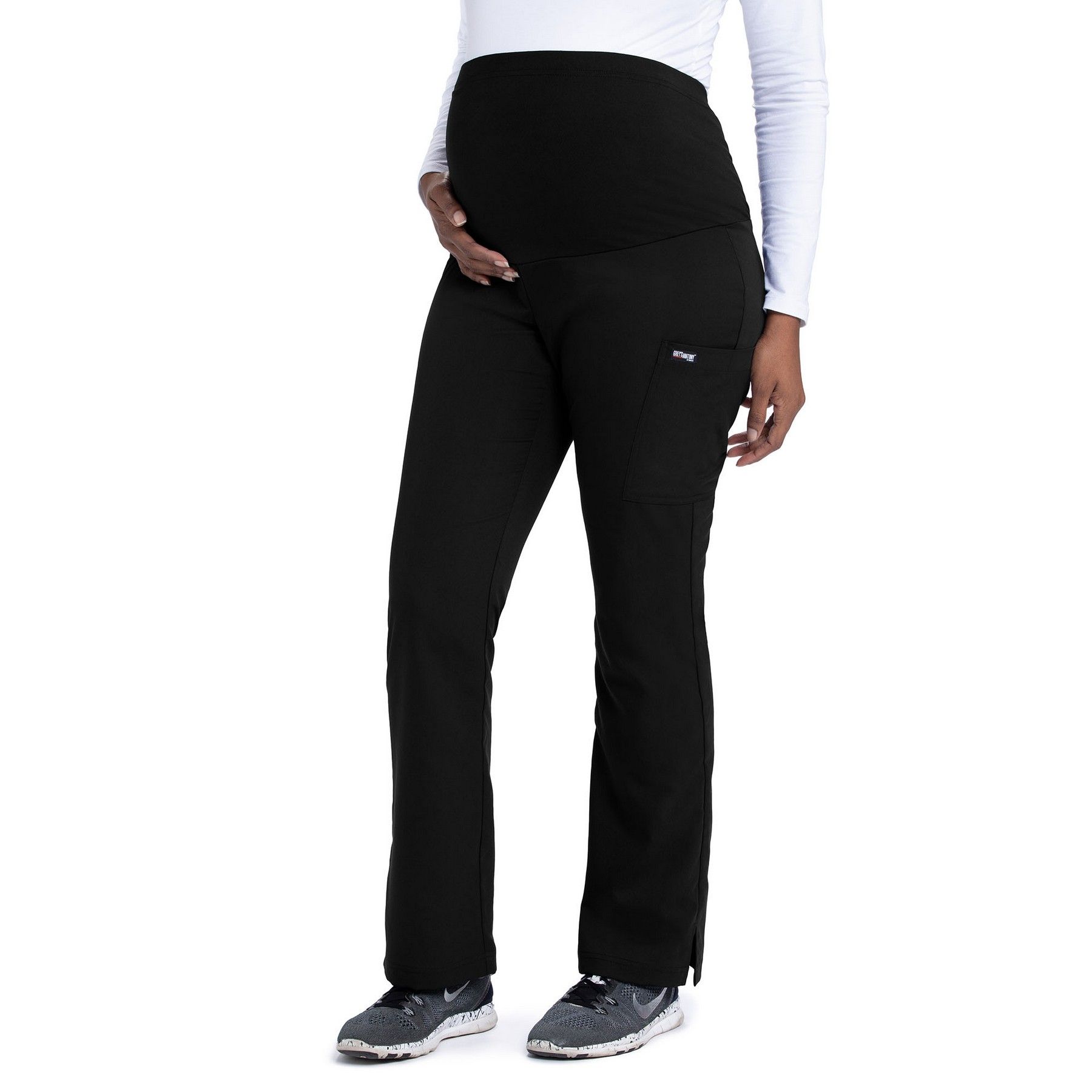 A pregnant woman is wearing black pants and a white shirt.