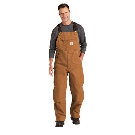 A man wearing brown overalls and a grey shirt