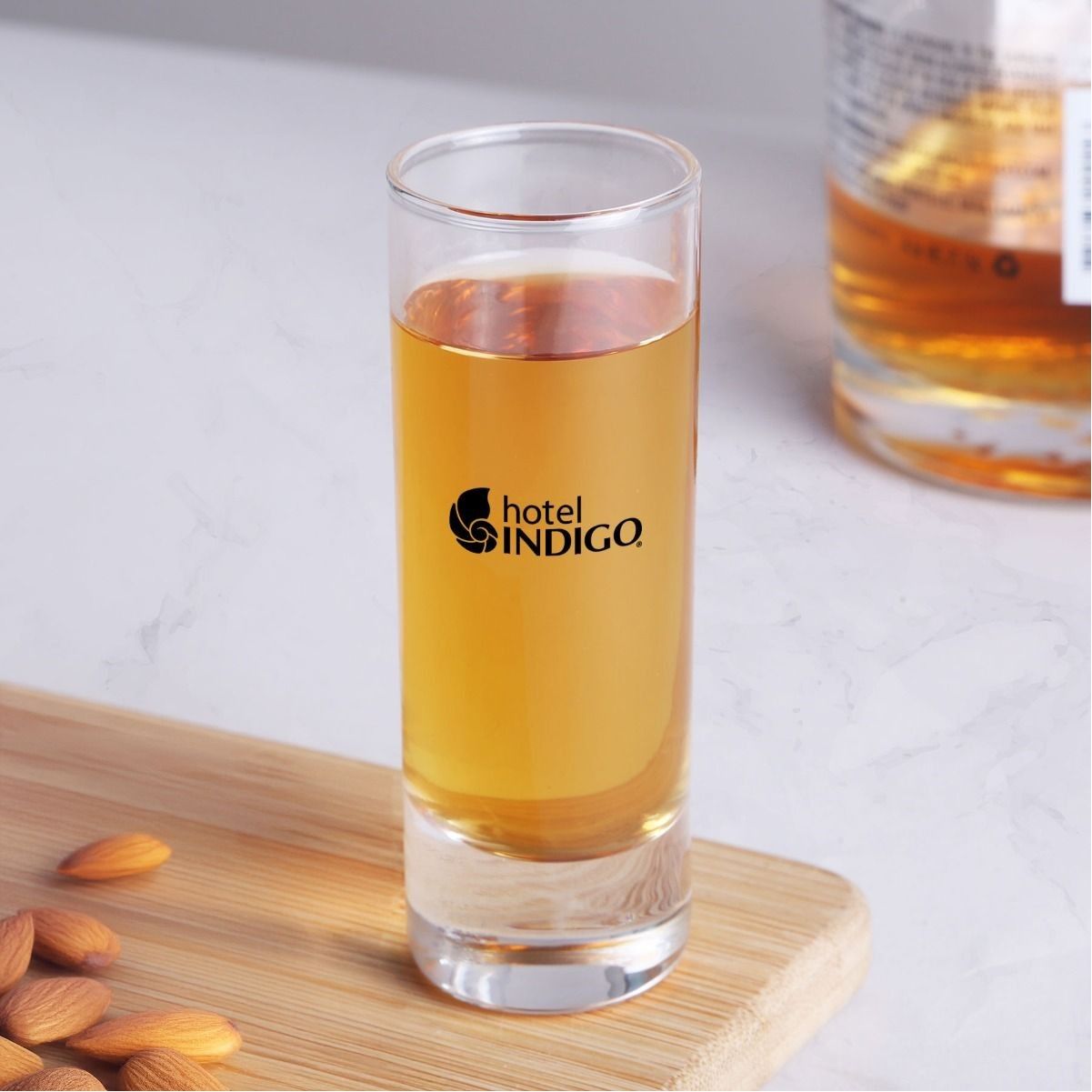A shot glass that says hotel indigo on it