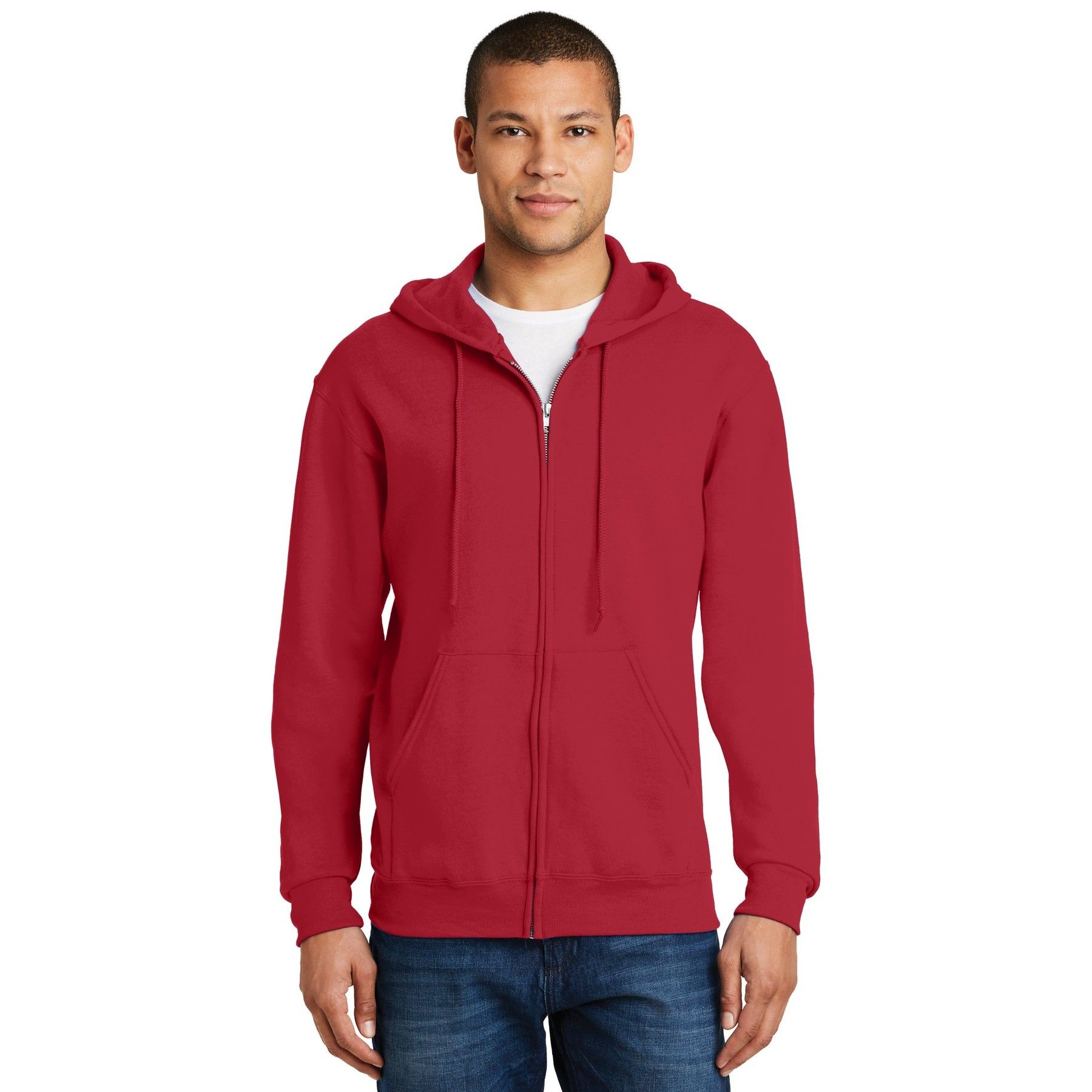A man is wearing a red zip up hoodie and jeans.