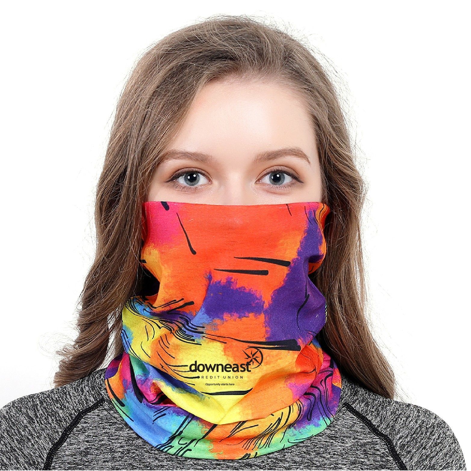 A woman is wearing a colorful scarf around her neck.