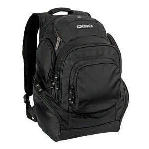 A black ogio backpack is sitting on a white surface.