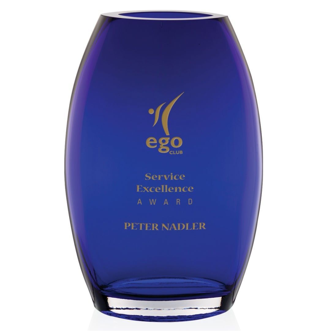 A blue glass vase with the name peter nadler on it
