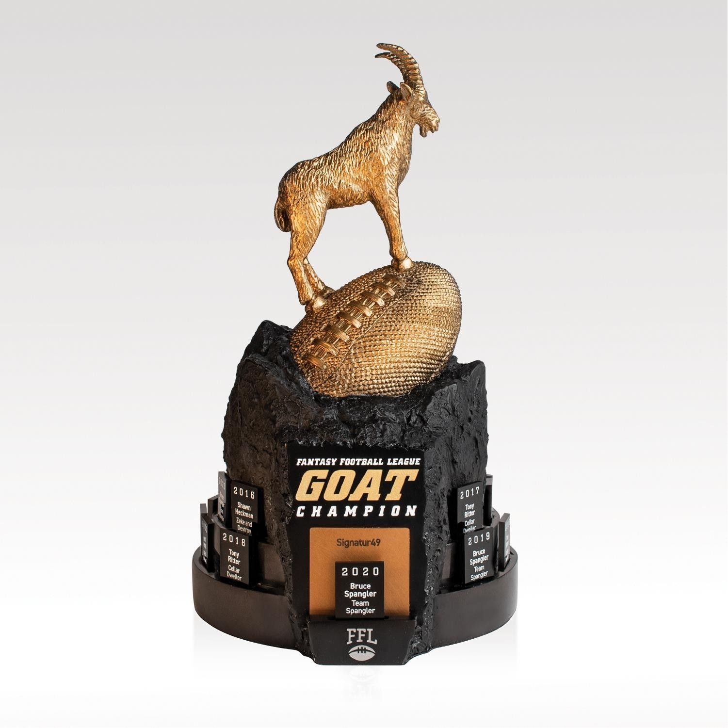 A trophy that says goat champion on it