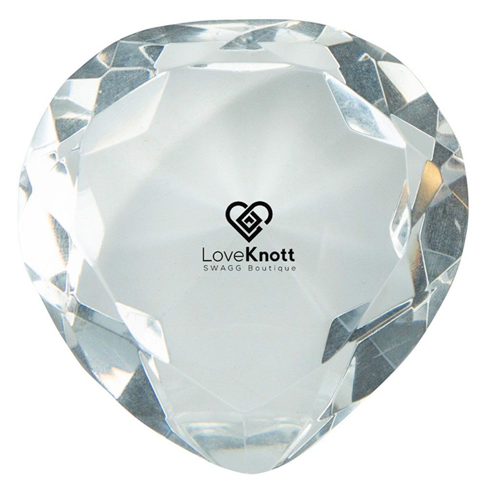 A heart shaped crystal with loveknott written on it