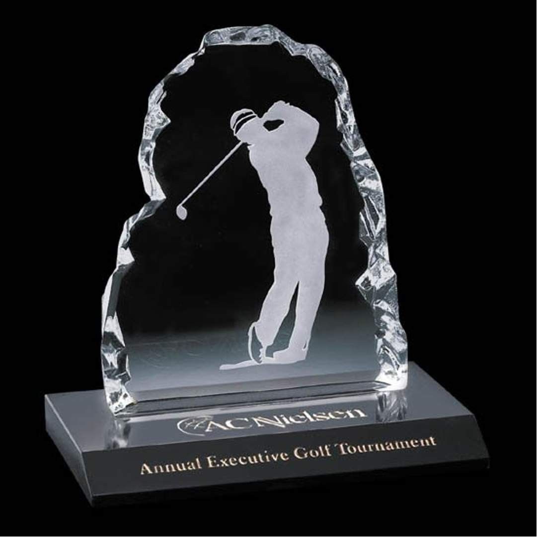 A glass trophy with a picture of a golfer on it