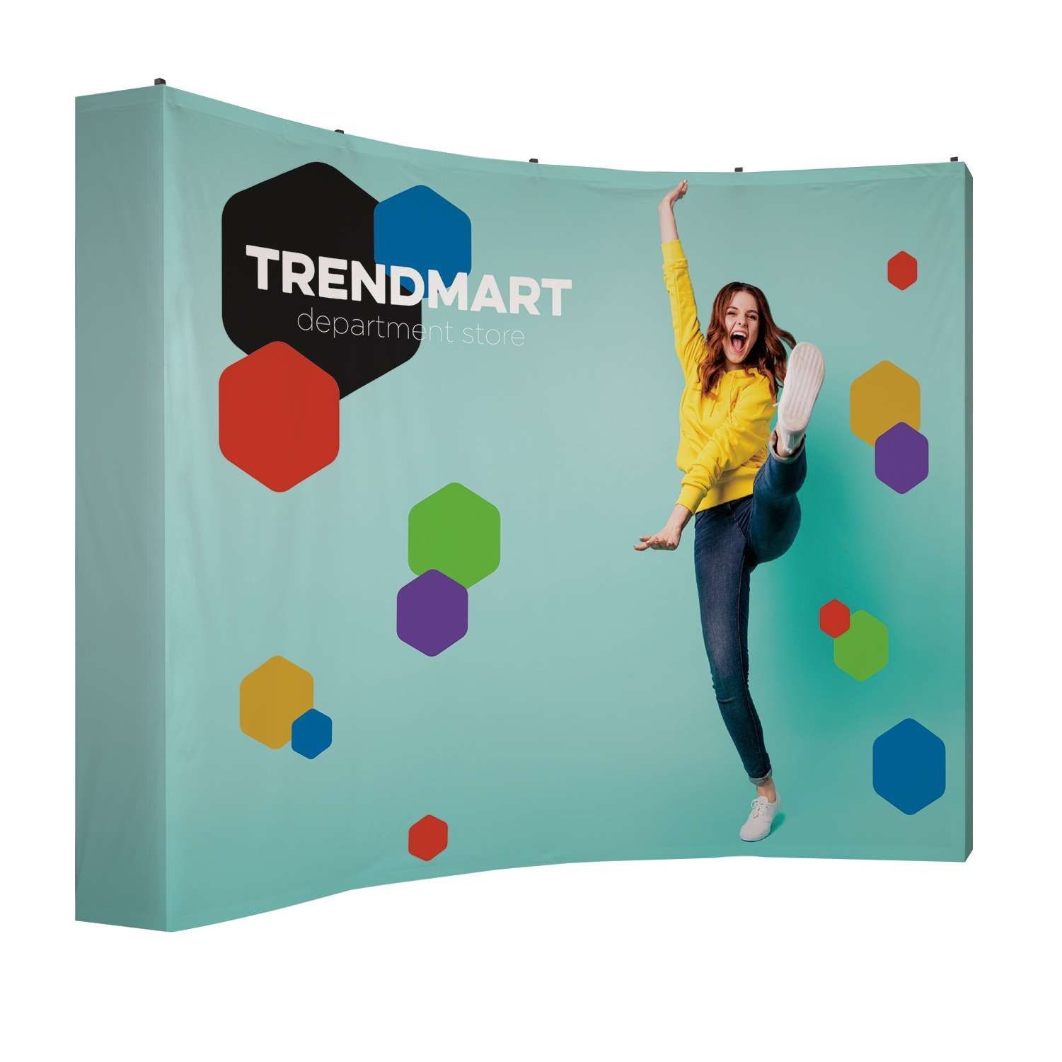 A woman is jumping in the air in front of a trendmart display.