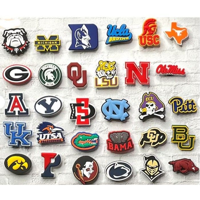 A variety of college football logos on a white brick wall.