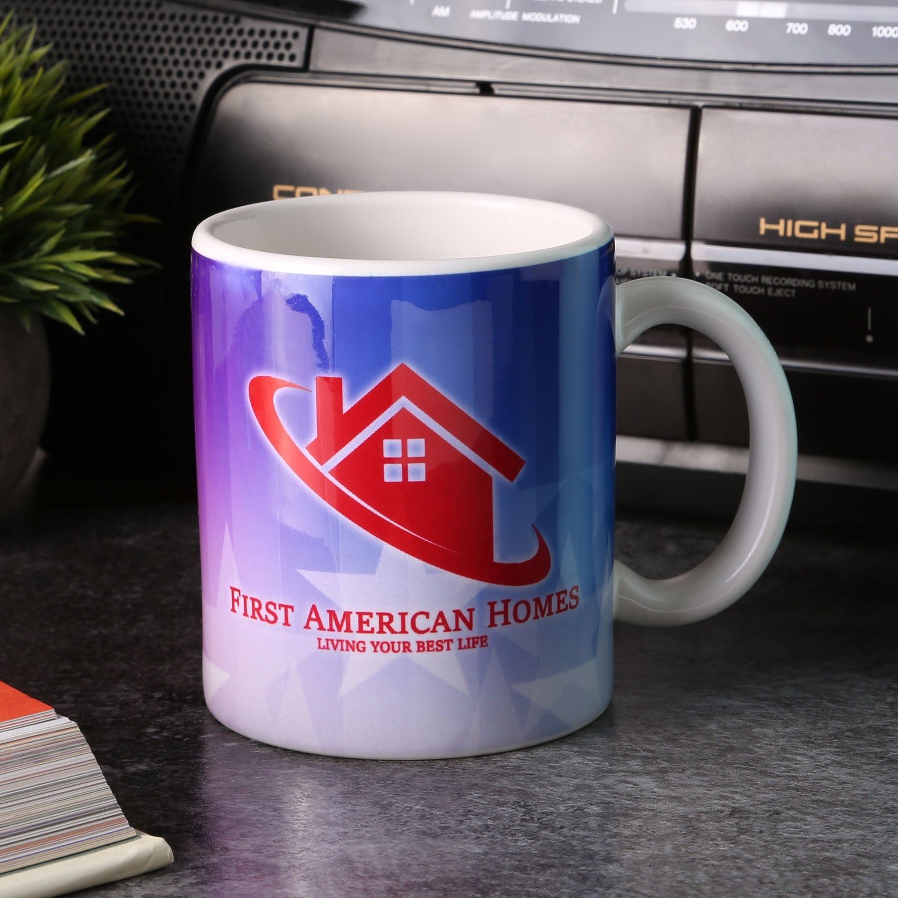 A black mug that says dasmah cafe on it