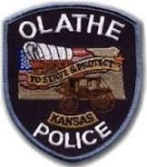 A patch for the olathe kansas police department with a police car on it.