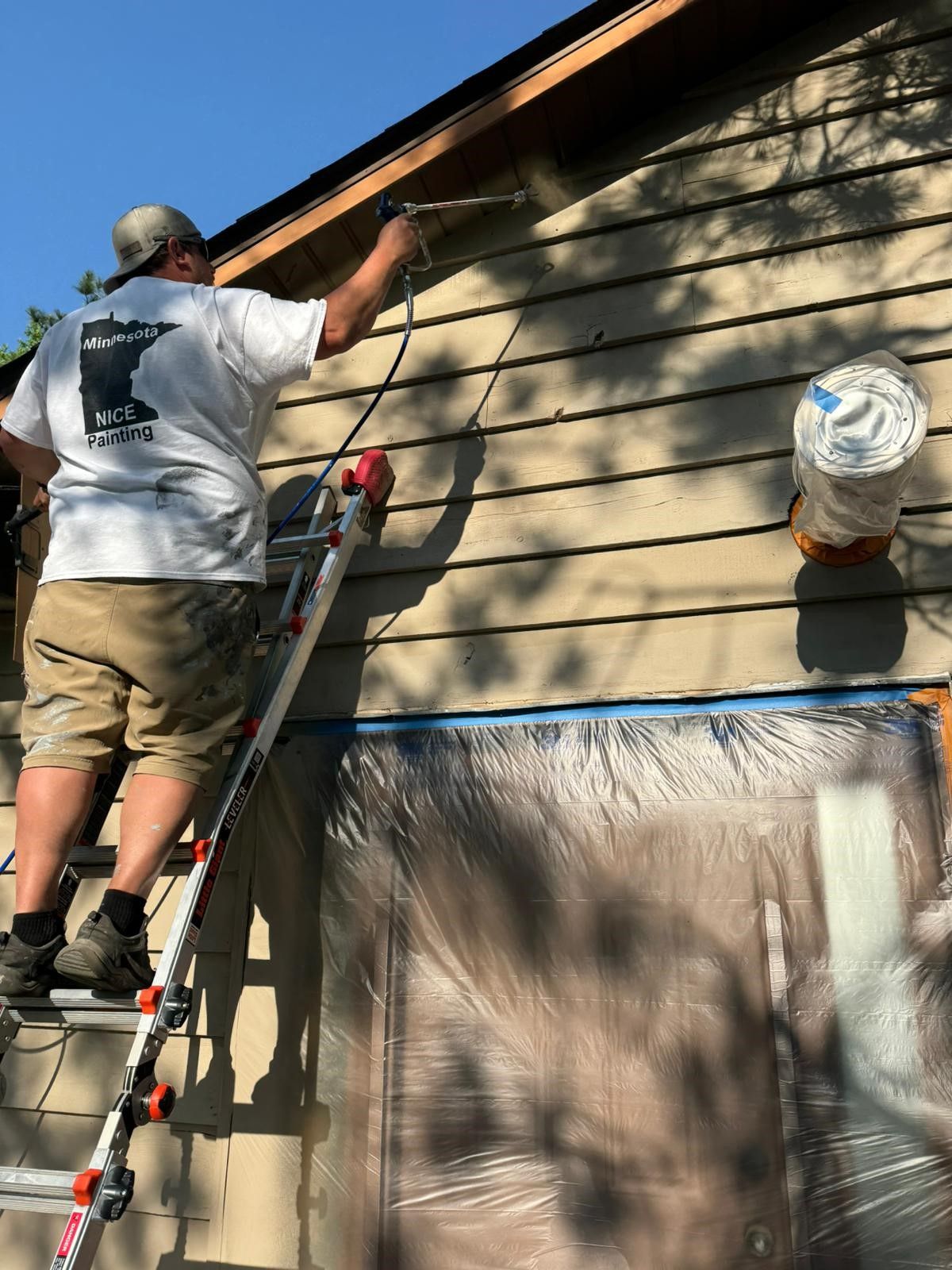 A Blue Boat Is Parked In Front Of A House Covered In Leaves – Cottage Grove, MN - Minnesota Nice Painting